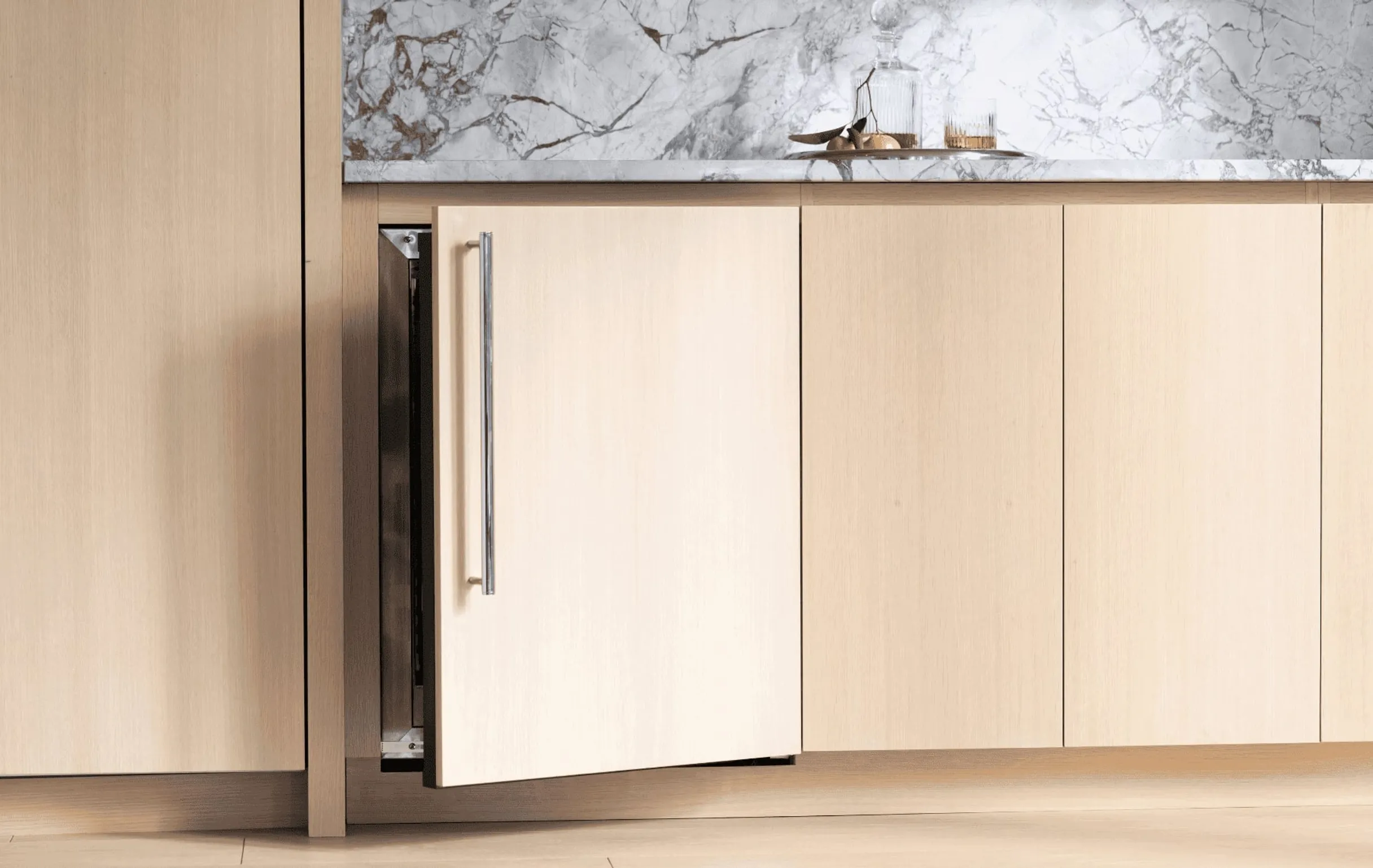 An undercounter beverage refrigerator with door left open